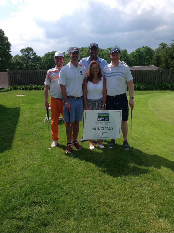 Mrs. O'Rourke surrounded by four golfers from the 2019 Annual SMS Scramble at Salem Golf Club