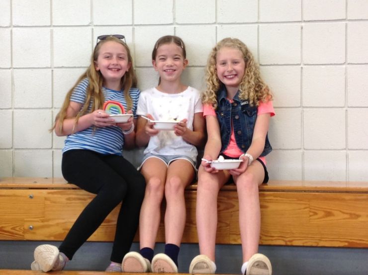 Three girls on the bleachers at the Back to School Ice Cream Social