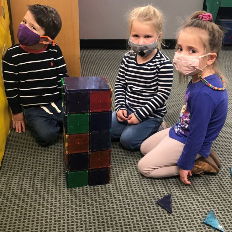 Preschool students building with Magnatiles during After Care